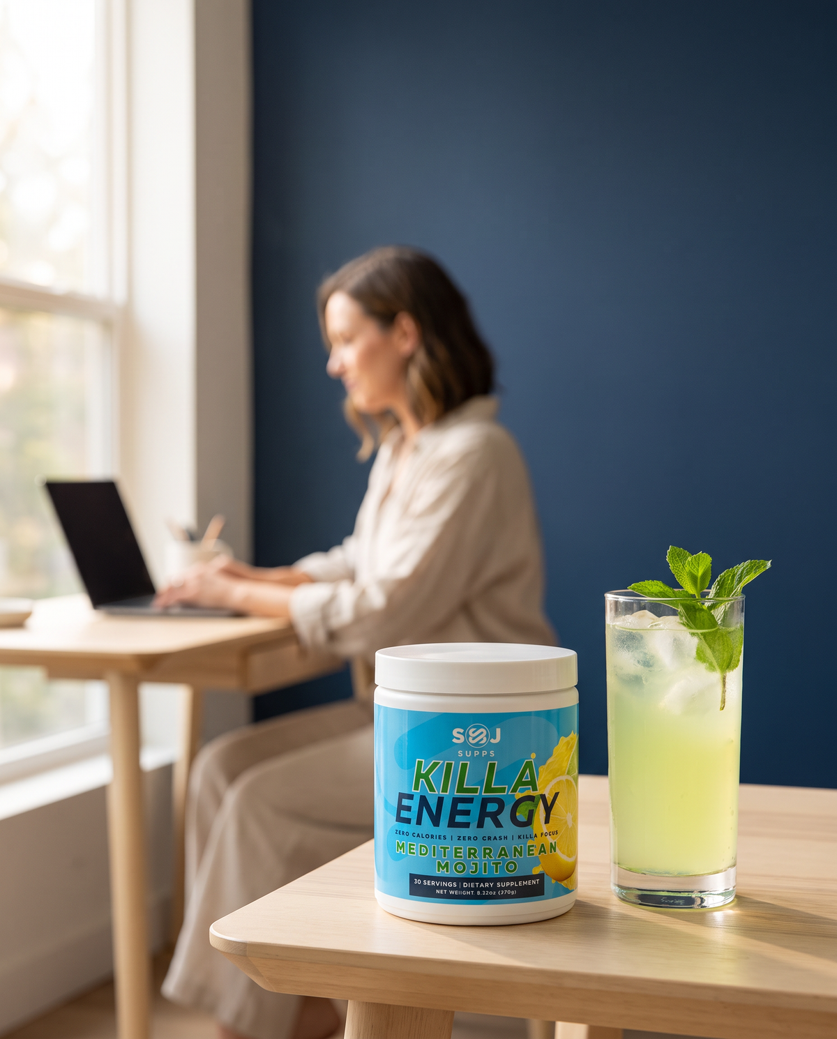 Killa Energy Mediterranean Mojito on a desk with a woman working behind
