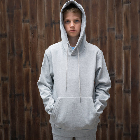 The Family Tracksuit - kid wearing hoodie with hood up, hands in pocket